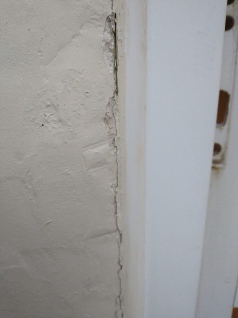 Cracks between render and UPVC frame.